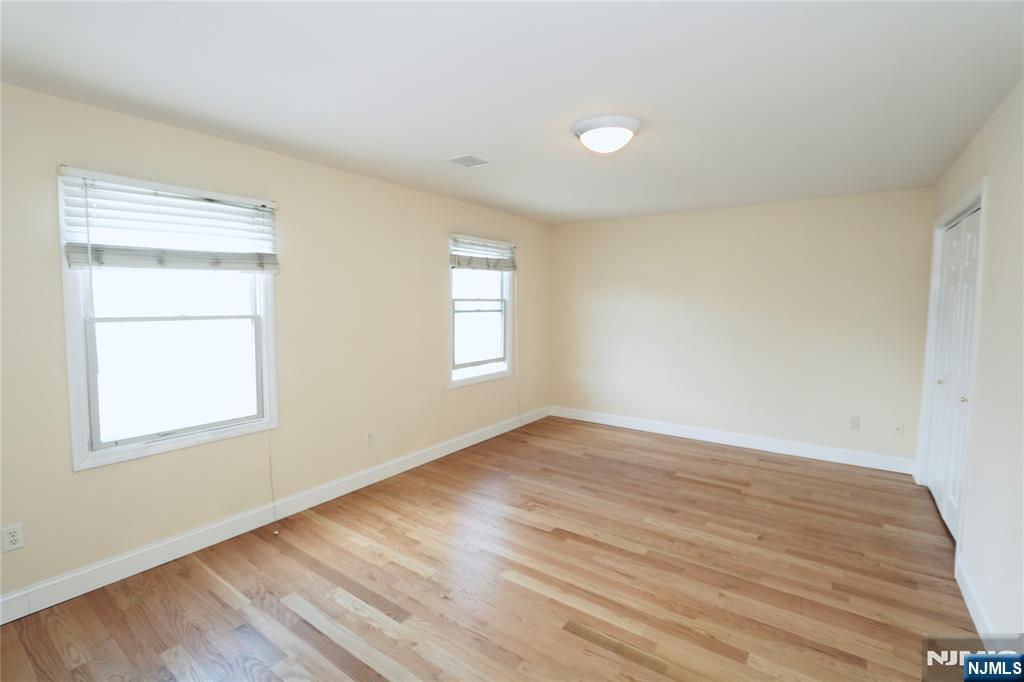 23 Main Avenue Wallington, NJ 07057 - Photo 25 of 29 an empty room with wooden floor and windows