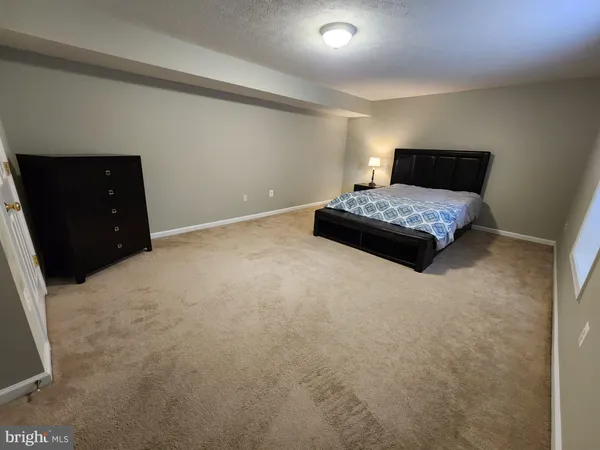 a bedroom with a bed and a black cabinet