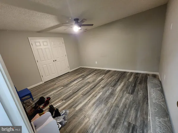 a view of a room with wooden floor and staircase