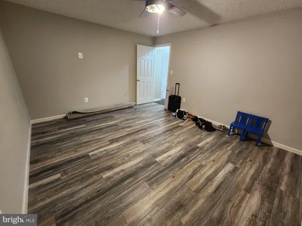 a view of a room with wooden floor and window