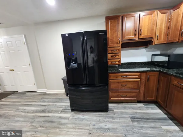 a kitchen with a refrigerator and cabinets