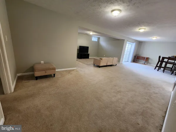 a living room with furniture and a lamp