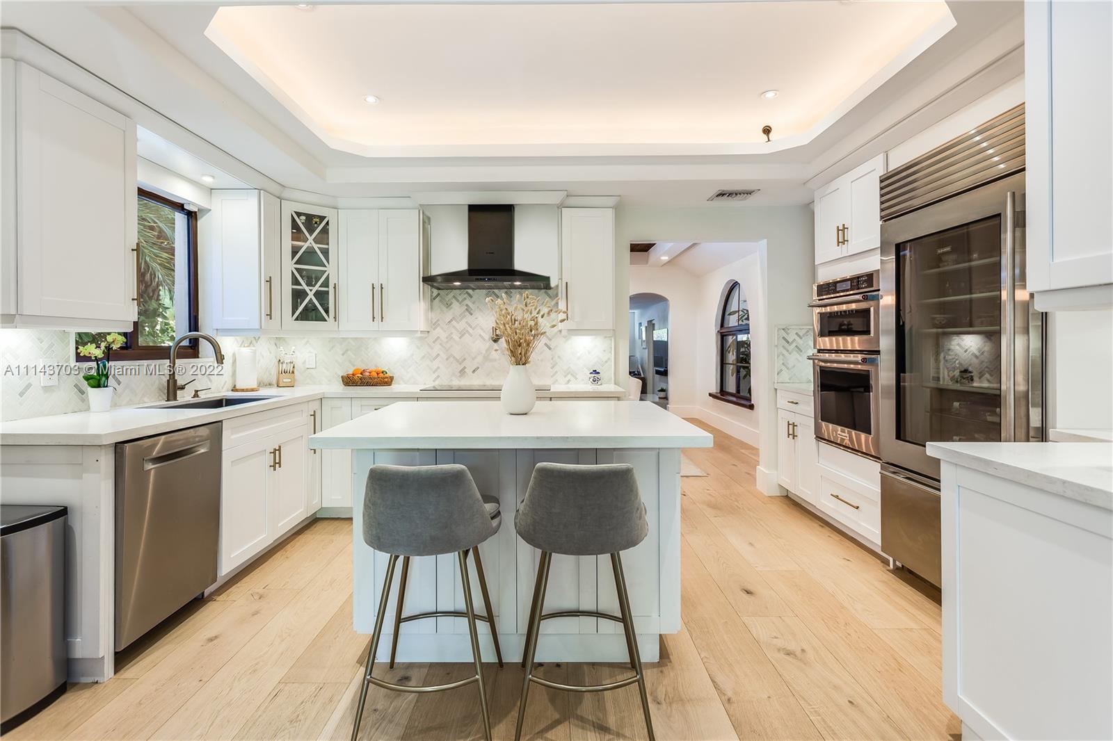 4422 Alton Road Miami Beach, FL 33140 - Photo 11 of 37 a kitchen with a sink cabinets and window