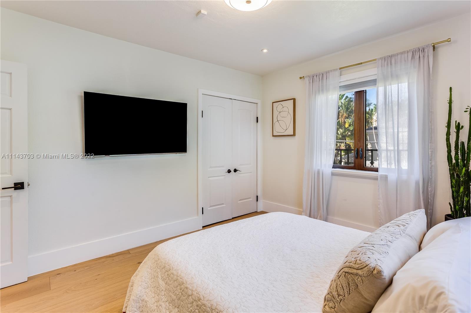 4422 Alton Road Miami Beach, FL 33140 - Photo 20 of 37 a bedroom with a bed and a flat screen tv