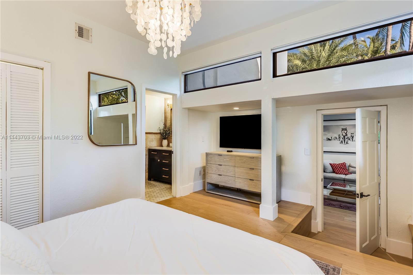 4422 Alton Road Miami Beach, FL 33140 - Photo 23 of 37 a bedroom with a bed and a flat tv screen on wall