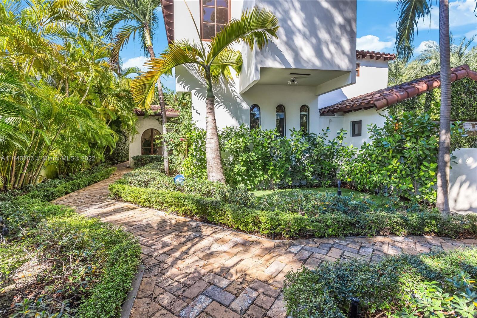4422 Alton Road Miami Beach, FL 33140 - Photo 31 of 37 a front view of a house with a yard and potted plants