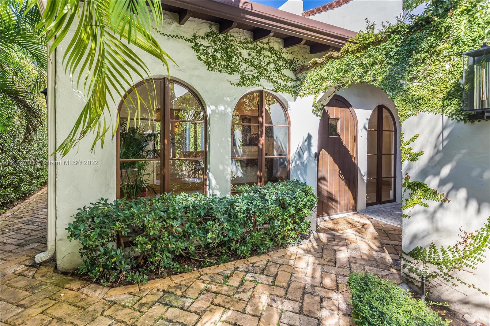 4422 Alton Road Miami Beach, FL 33140 - Photo 33 of 37 a front view of a house with garden