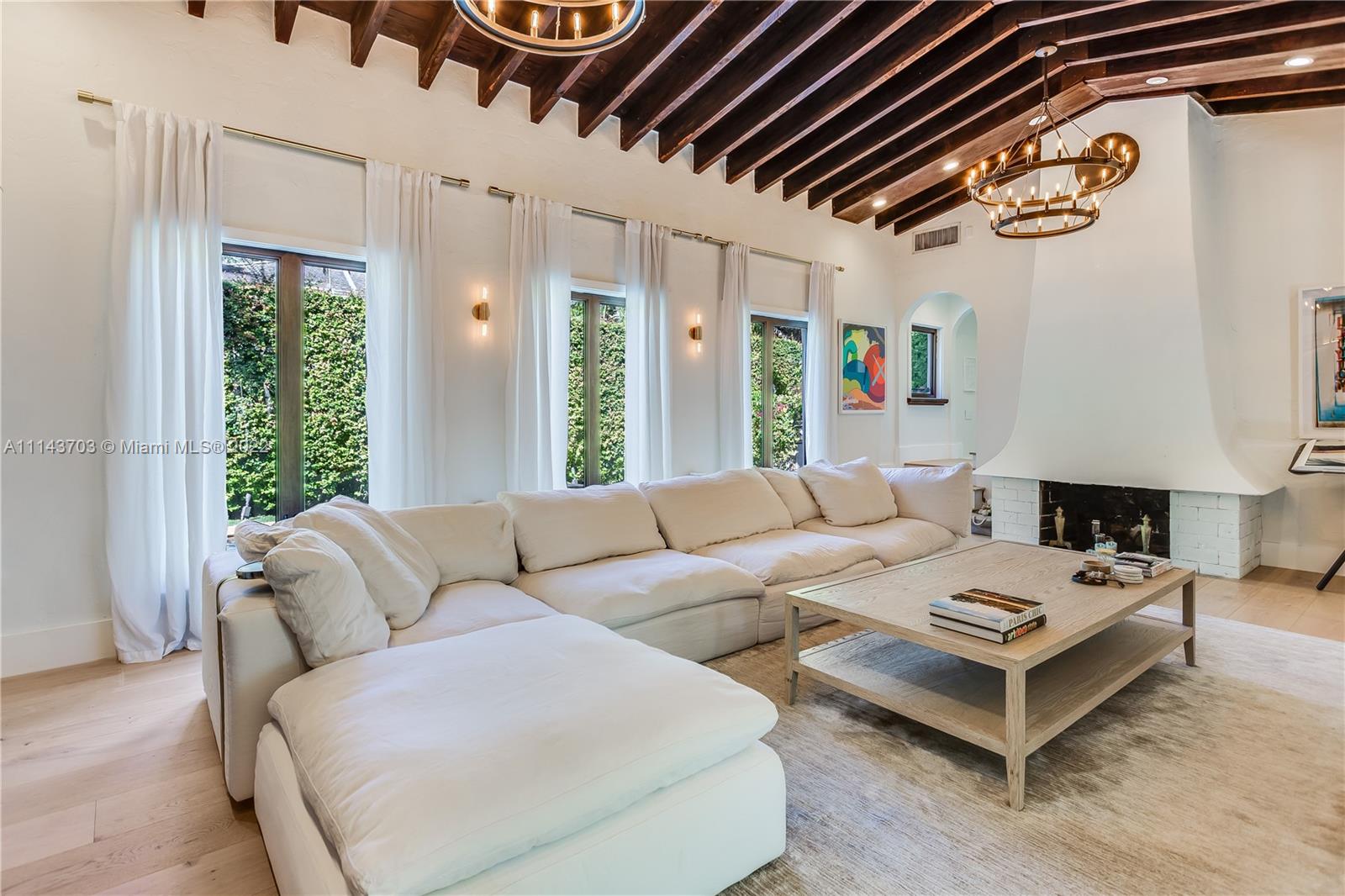 4422 Alton Road Miami Beach, FL 33140 - Photo 4 of 37 a living room with furniture a rug and a large window