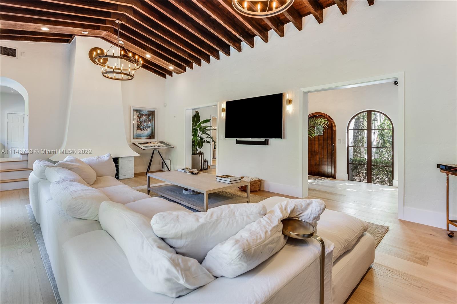 4422 Alton Road Miami Beach, FL 33140 - Photo 5 of 37 a living room with furniture and a flat screen tv