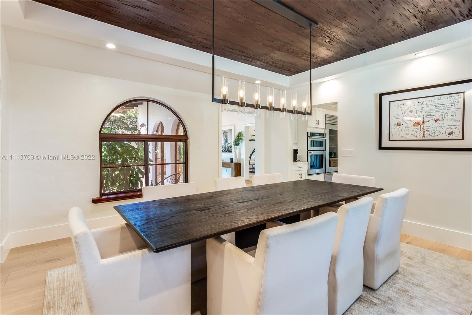 4422 Alton Road Miami Beach, FL 33140 - Photo 8 of 37 a dining table with a large window