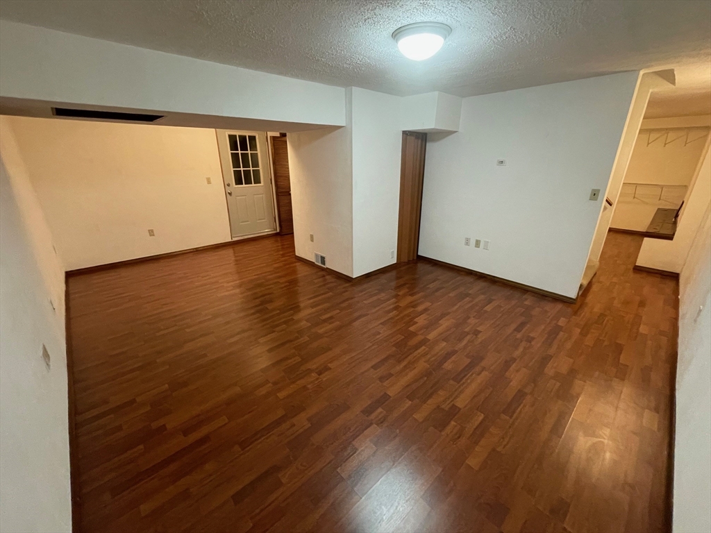 16 Bowstring Way Marlborough, MA 01752 - Photo 19 of 25 an empty room with wooden floor and windows