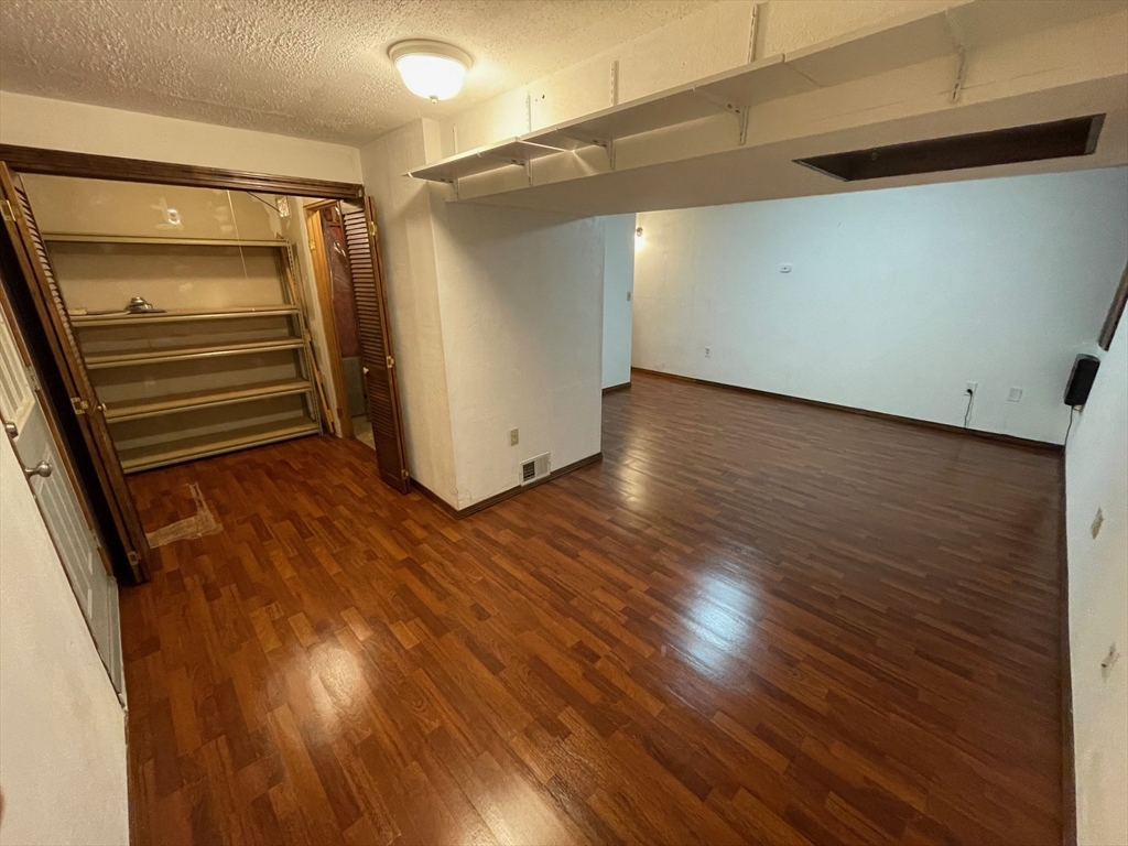 16 Bowstring Way Marlborough, MA 01752 - Photo 20 of 25 a view of an empty room with wooden floor and stairs