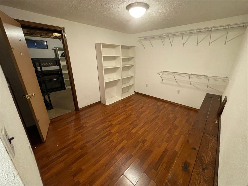 16 Bowstring Way Marlborough, MA 01752 - Photo 21 of 25 wooden floor in an empty room with a fireplace