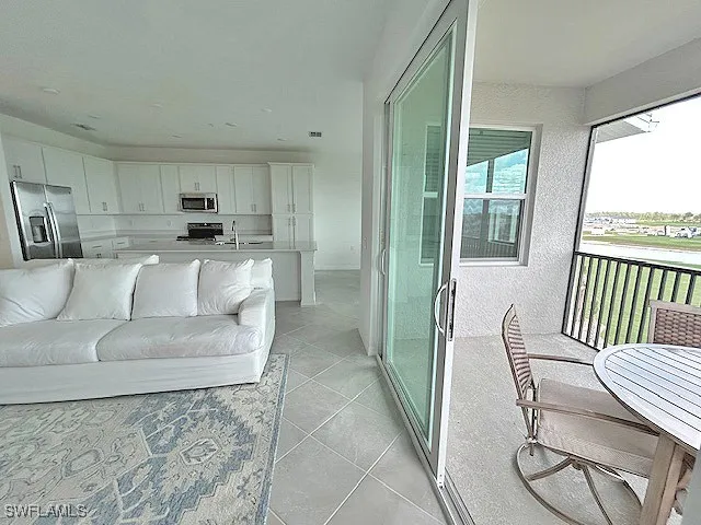 a living room with furniture and a large window