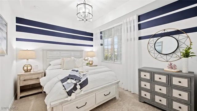 a bedroom with a bed a mirror and a window