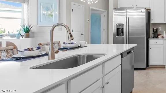 a kitchen with stainless steel appliances granite countertop a sink and a refrigerator