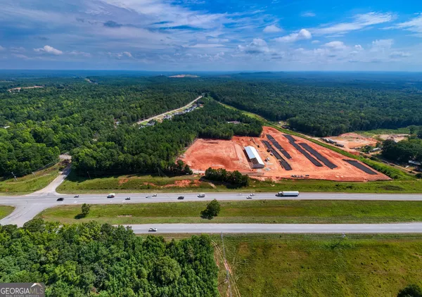 an aerial view of a residential houses with yard
