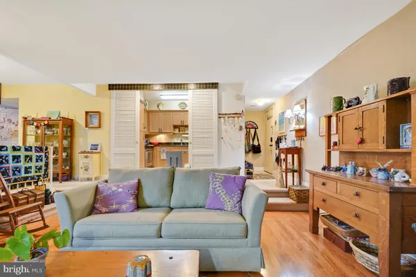 a living room with furniture and a walk in closet with a large window