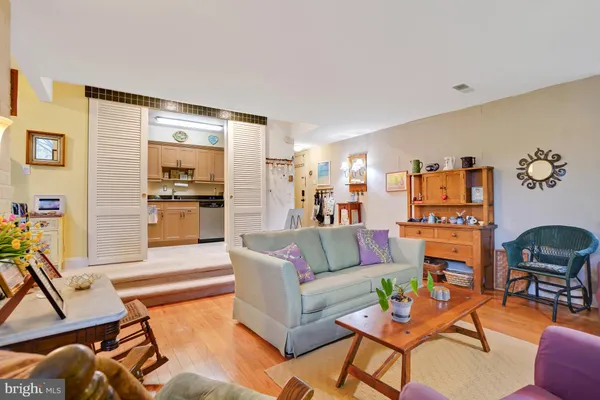 a living room with furniture kitchen view and a dining table
