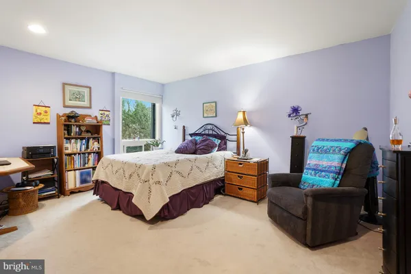 a spacious bedroom with a bed couch and a window
