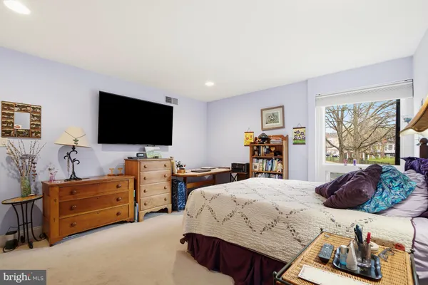 a bedroom with a bed and flat screen tv