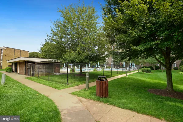 a view of a house with a backyard and a tree