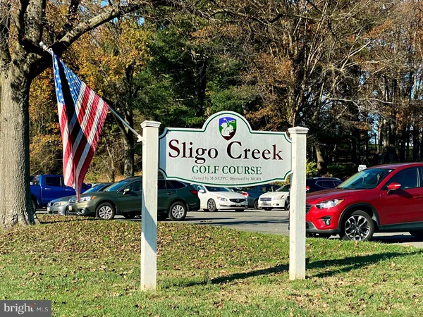 a view of a street with cars and trees