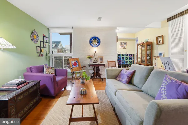 a living room with furniture a rug and a table