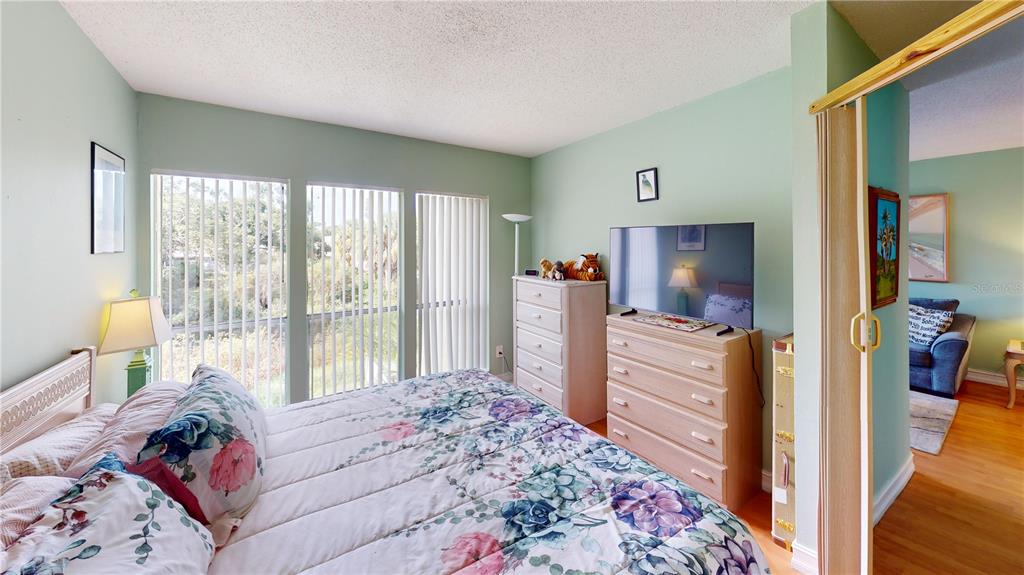 3415 Clark Road, Unit 215 Sarasota, FL 34231 - Photo 11 of 18 a bedroom with a bed and large windows