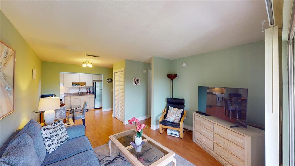 3415 Clark Road, Unit 215 Sarasota, FL 34231 - Photo 11 of 18 a living room with furniture and a flat screen tv