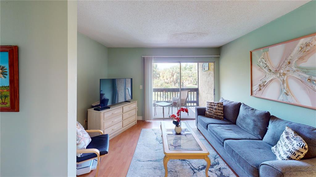 3415 Clark Road, Unit 215 Sarasota, FL 34231 - Photo 13 of 18 a living room with furniture and a couch