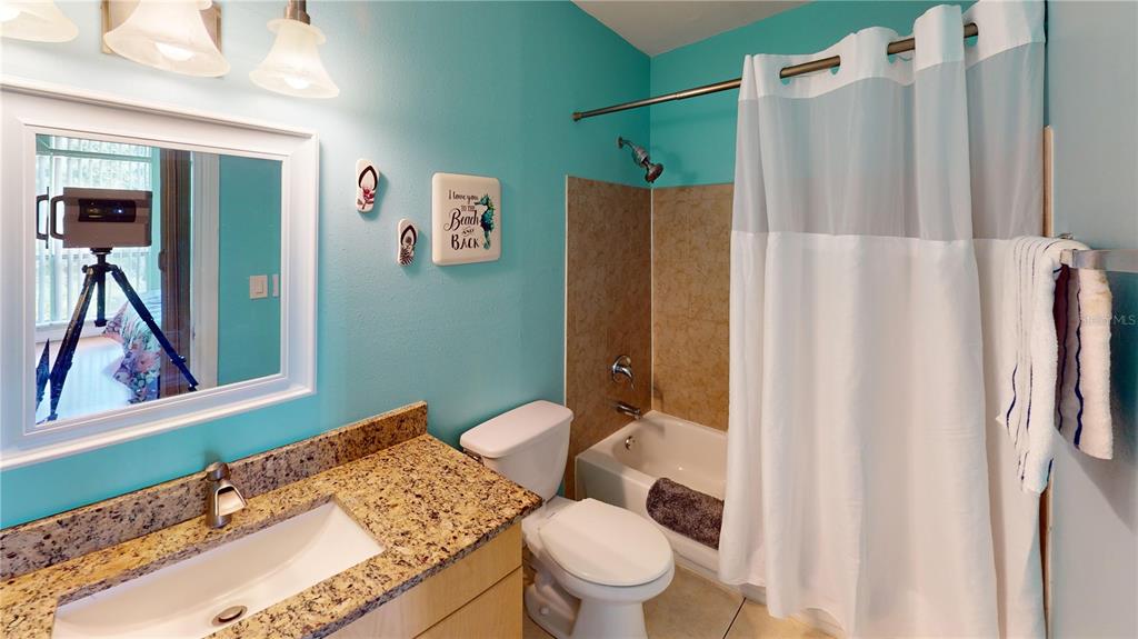 3415 Clark Road, Unit 215 Sarasota, FL 34231 - Photo 14 of 18 a bathroom with a granite countertop sink toilet and shower