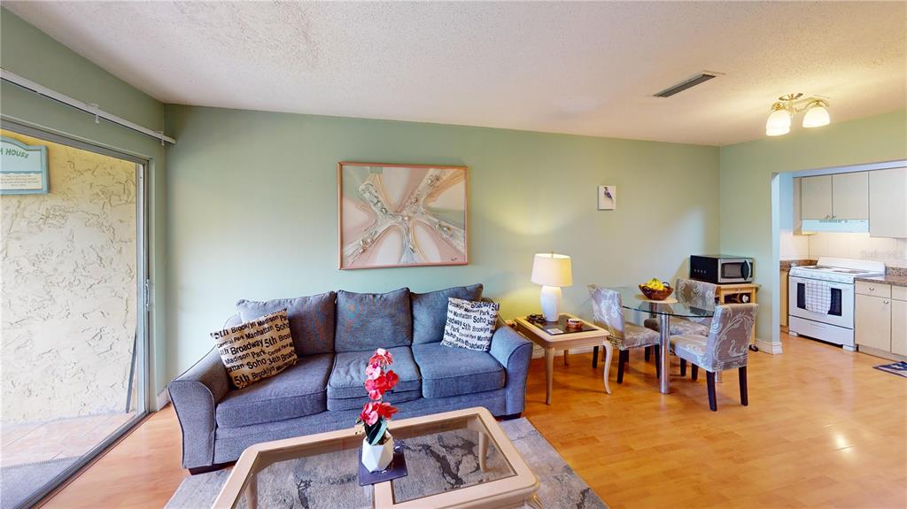 3415 Clark Road, Unit 215 Sarasota, FL 34231 - Photo 6 of 18 a living room with furniture and wooden floor