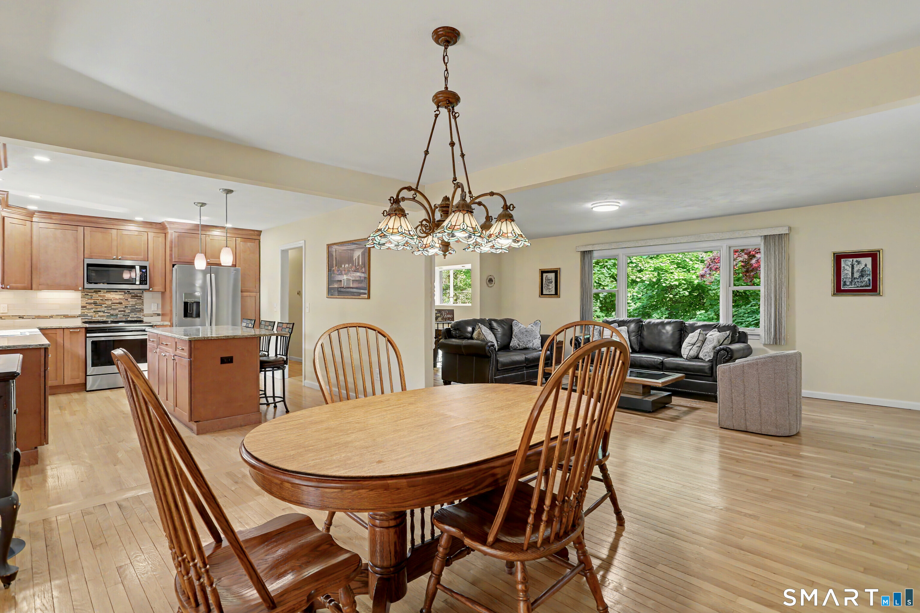 632 Wheelers Farm Road Orange, CT 06477 - Photo 11 of 39 a view of a dining room with furniture window and wooden floor