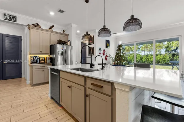 a kitchen with stainless steel appliances granite countertop a sink a stove and a refrigerator