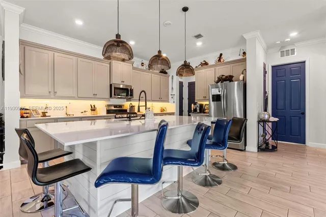 a kitchen with cabinets and chairs