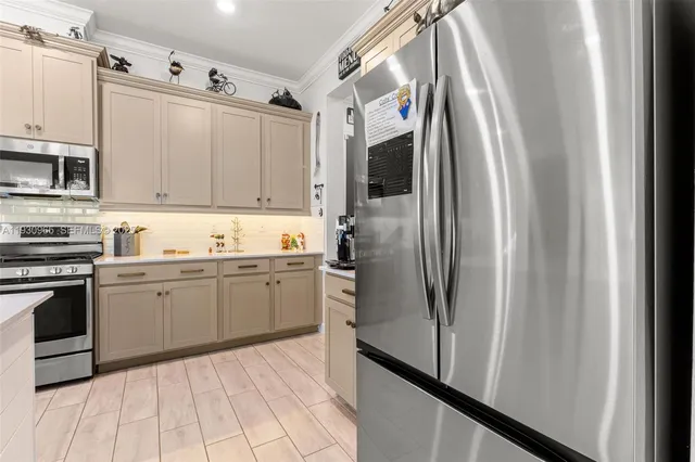 a kitchen with granite countertop a refrigerator and a sink