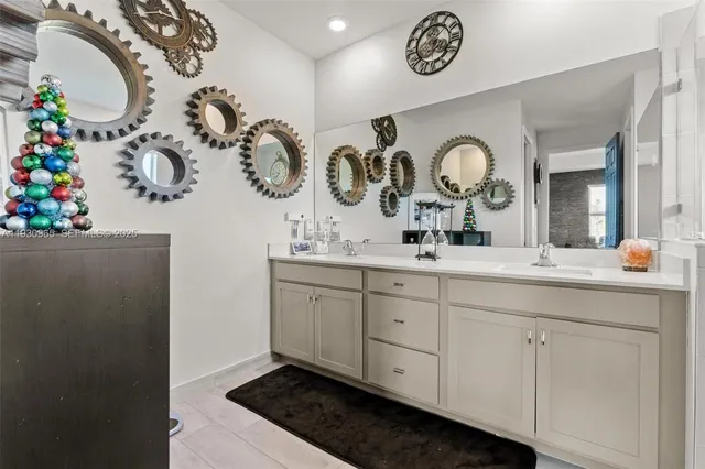a bathroom with a sink mirror and vanity