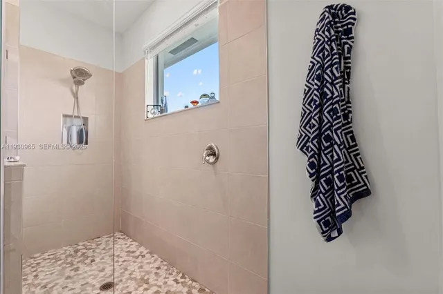 a bathroom with a window and a shower