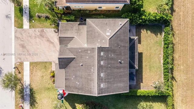 an aerial view of a house with a yard