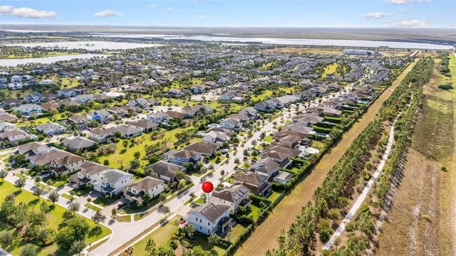 an aerial view of a house with a yard basket ball court and outdoor seating
