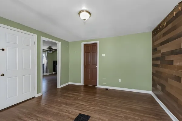 an empty room with wooden floor and closet