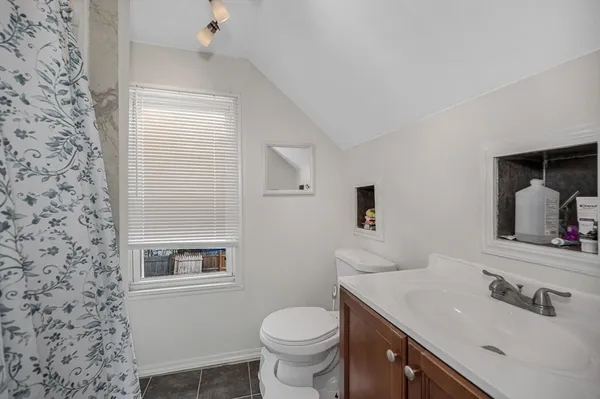 a bathroom with a toilet sink and mirror