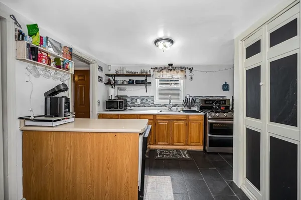 a kitchen with stainless steel appliances a refrigerator and a stove