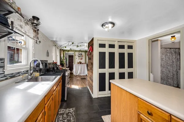 a kitchen with stainless steel appliances kitchen island granite countertop a sink and wooden cabinets