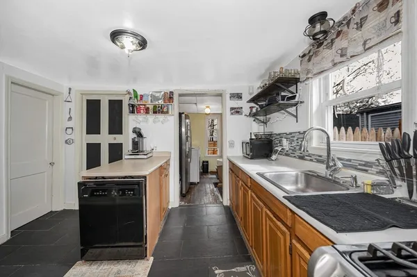 a kitchen with stainless steel appliances granite countertop a sink and stove