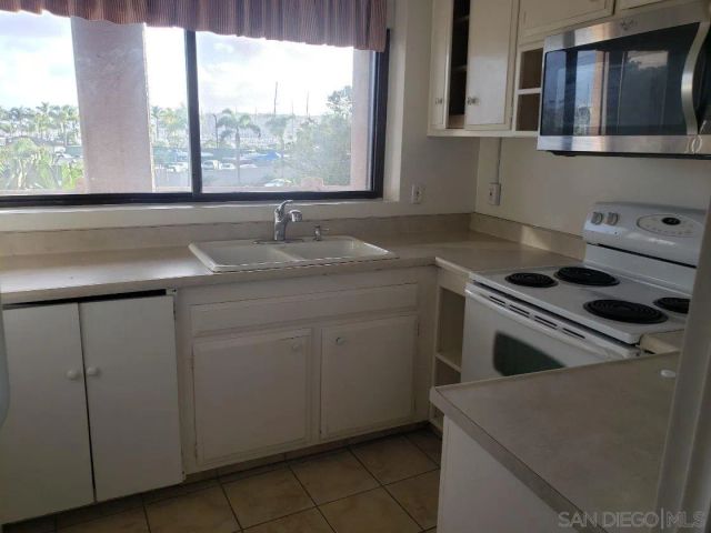 a sink with a painting on the wall