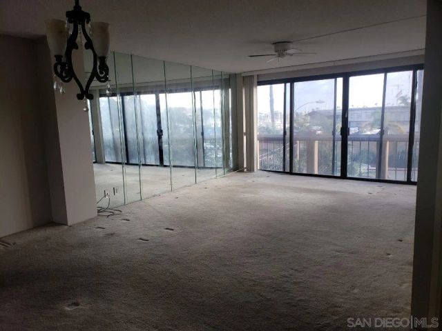 a view of a room with wooden floor and a window