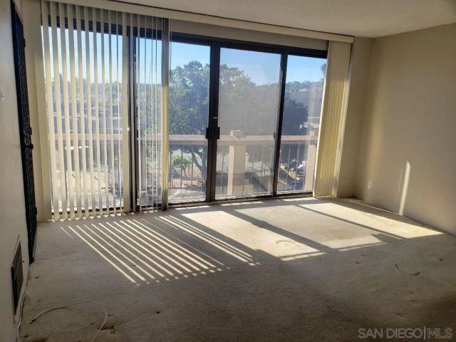 a view of a big room with windows and entryway