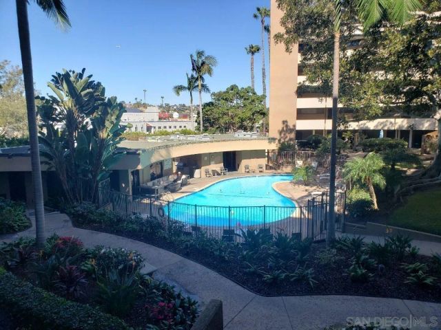 a view of a patio with table and chairs under an umbrella